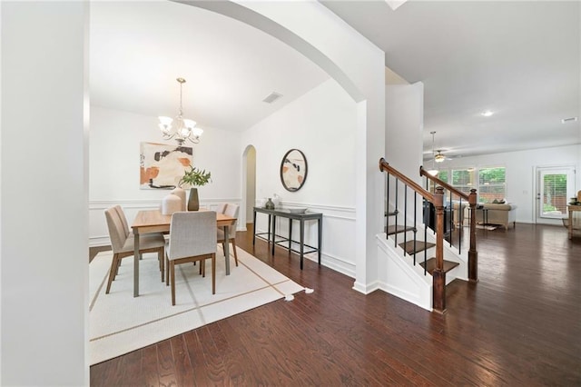 123 Meridian Dr, Woodstock, GA 30188 - dining area with arched walkways, wood finished floors, stairs, a chandelier, and ceiling fan