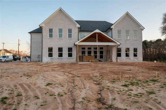 back of property featuring brick siding