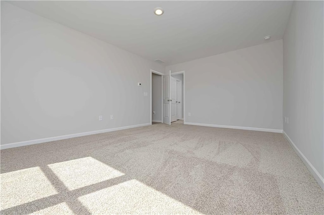 unfurnished room featuring light colored carpet, recessed lighting, and baseboards