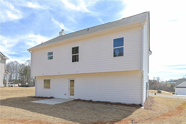 rear view of property with a chimney