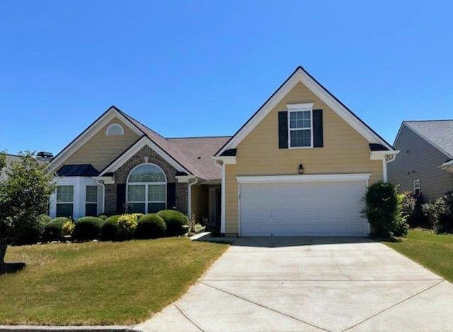 view of front of home with a garage and a front lawn