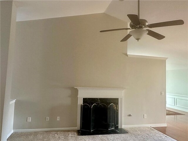 unfurnished dining area with lofted ceiling, a chandelier, dark wood-style floors, visible vents, and wainscoting