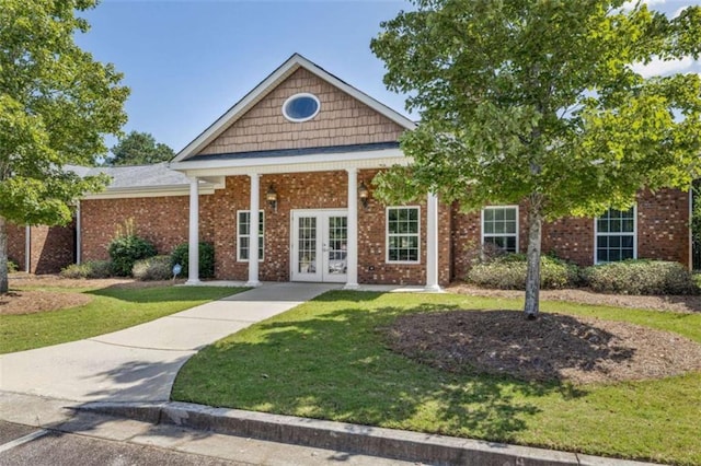 view of front of house with a front yard and french doors