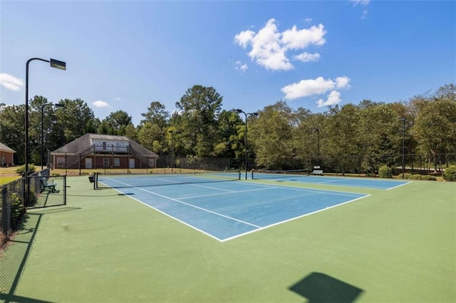 view of tennis court featuring basketball hoop