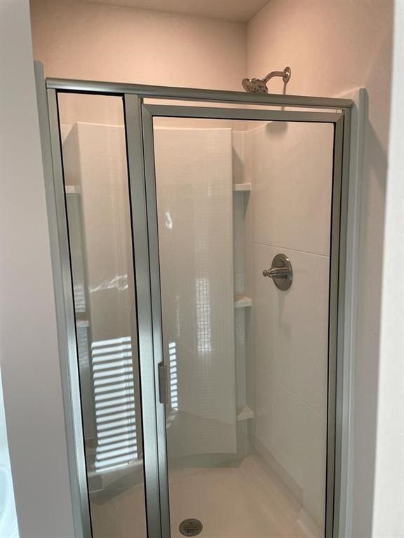 bathroom featuring a shower with door