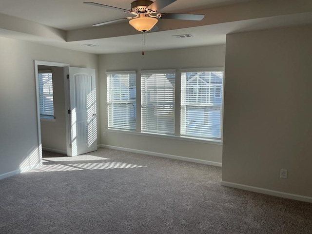 carpeted empty room featuring plenty of natural light and ceiling fan