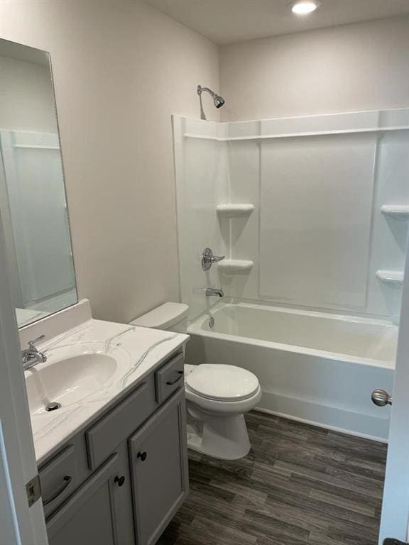 full bathroom featuring shower / tub combination, wood-type flooring, toilet, and vanity