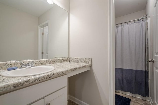 bathroom featuring curtained shower and vanity