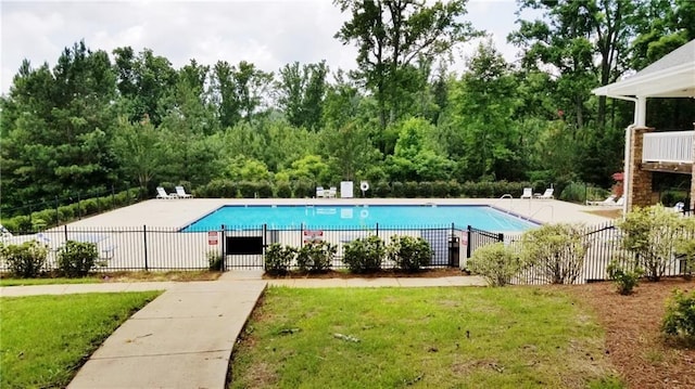 pool with a patio area, a yard, and fence