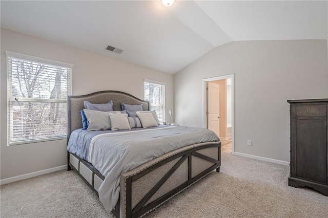 bedroom with visible vents, baseboards, ensuite bath, lofted ceiling, and light colored carpet