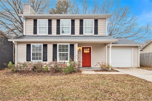 view of front property featuring a garage and a front lawn