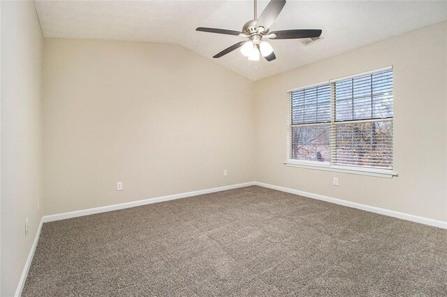 carpeted spare room with ceiling fan and lofted ceiling