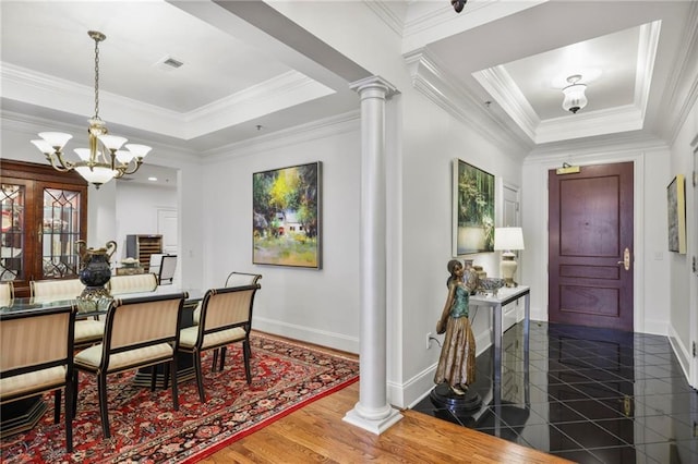 dining area featuring crown molding, a tray ceiling, visible vents, and ornate columns