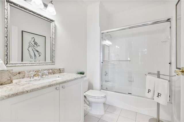 bathroom featuring toilet, shower / bath combination with glass door, tile patterned flooring, crown molding, and vanity