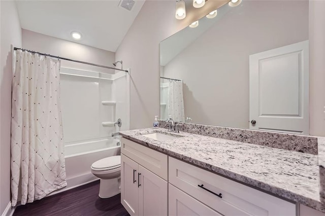 full bathroom featuring hardwood / wood-style floors, vanity, toilet, and shower / bath combo with shower curtain