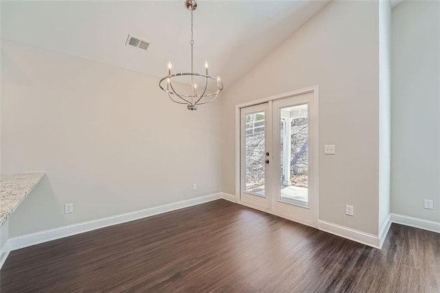 unfurnished dining area with a chandelier, french doors, dark hardwood / wood-style floors, and high vaulted ceiling