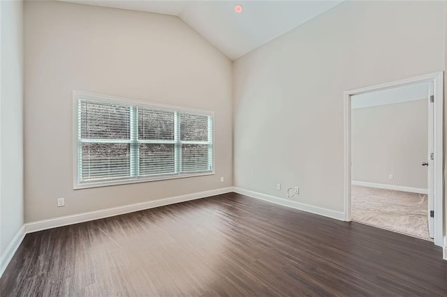 spare room featuring dark hardwood / wood-style floors and high vaulted ceiling