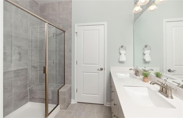 bathroom with tile patterned floors, vanity, and a shower with shower door