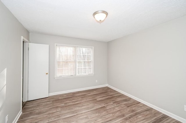 3406 Blackberry Ln, Villa Rica, GA 30180 - spare room with wood finished floors and a textured ceiling