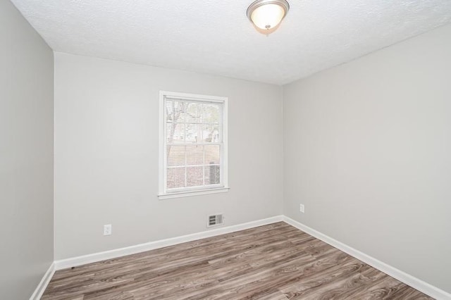 3406 Blackberry Ln, Villa Rica, GA 30180 - spare room featuring wood finished floors and a textured ceiling