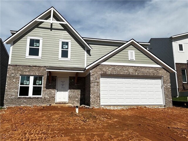 40 Cava Ter, Braselton, GA 30517 - view of front of property featuring brick siding, a front yard, driveway, and a garage