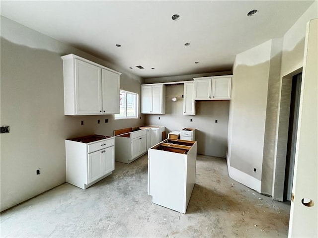 40 Cava Ter, Braselton, GA 30517 - kitchen featuring a center island, concrete floors, and white cabinets