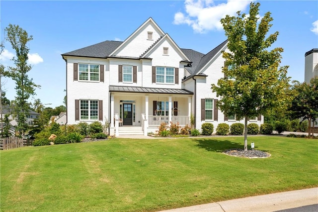 view of front facade featuring covered porch and a front lawn