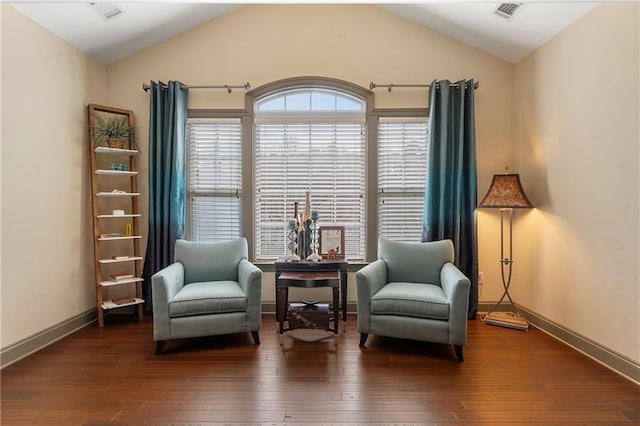 sitting room featuring dark hardwood / wood-style flooring and lofted ceiling