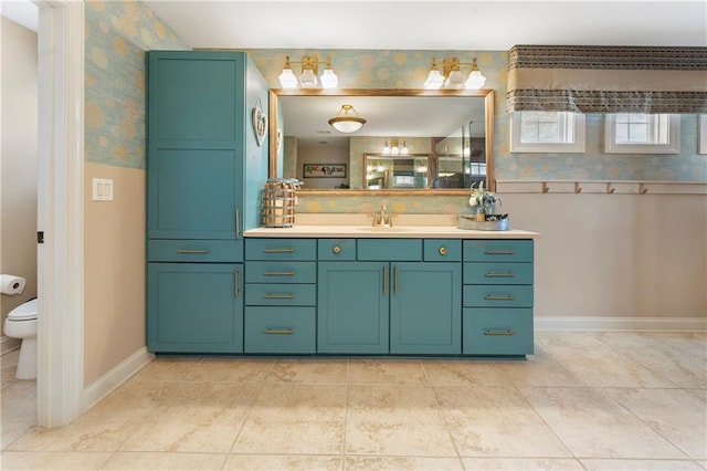 bathroom featuring toilet, vanity, and tile patterned floors