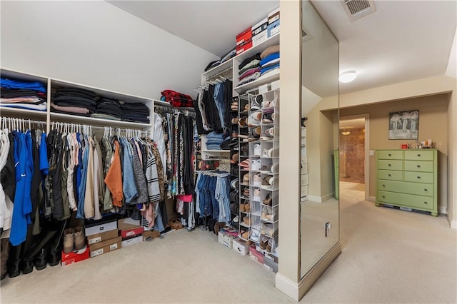 walk in closet featuring carpet