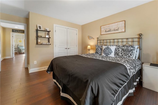 bedroom with a closet and dark hardwood / wood-style flooring