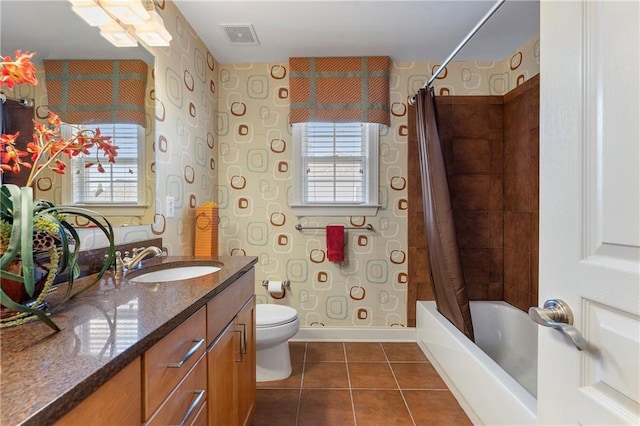 full bathroom with toilet, tile patterned floors, vanity, and shower / bath combo with shower curtain