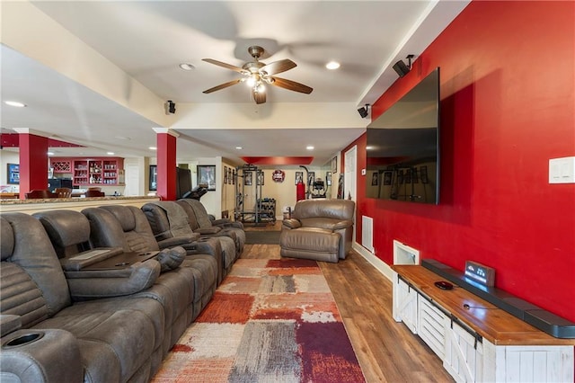 living room featuring ceiling fan and dark hardwood / wood-style floors