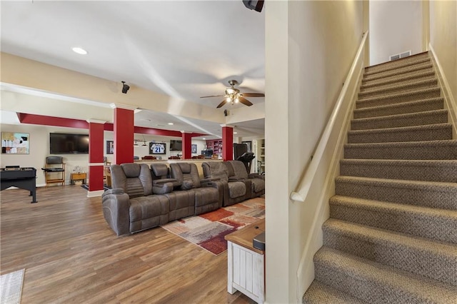 living room with ceiling fan, hardwood / wood-style floors, and decorative columns