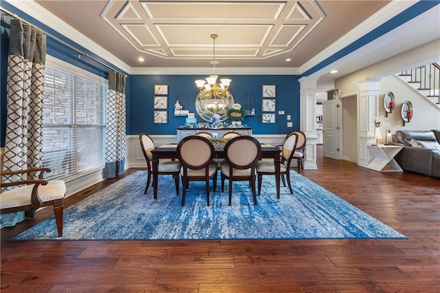 dining area with dark hardwood / wood-style floors, crown molding, and a notable chandelier