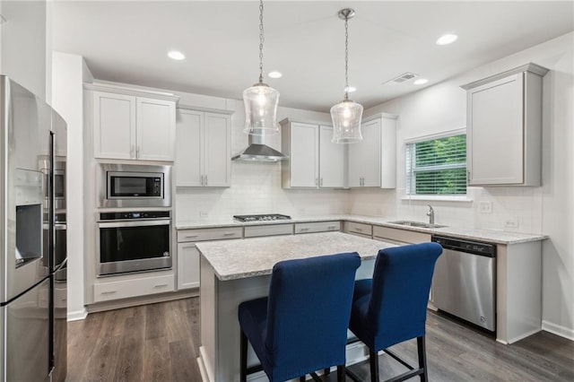 6360 Boulder Rdg, Cumming, GA 30028 - kitchen with appliances with stainless steel finishes, wall chimney exhaust hood, a sink, backsplash, and recessed lighting