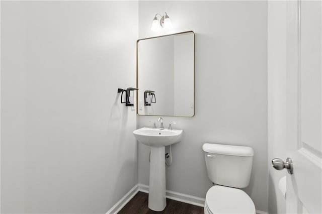6360 Boulder Rdg, Cumming, GA 30028 - bathroom with baseboards, toilet, wood finished floors, and a sink