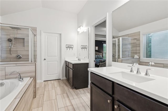 6360 Boulder Rdg, Cumming, GA 30028 - bathroom with vaulted ceiling, a stall shower, two vanities, and a garden tub