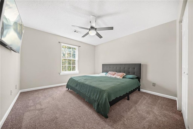 carpeted bedroom with ceiling fan, visible vents, a textured ceiling, and baseboards