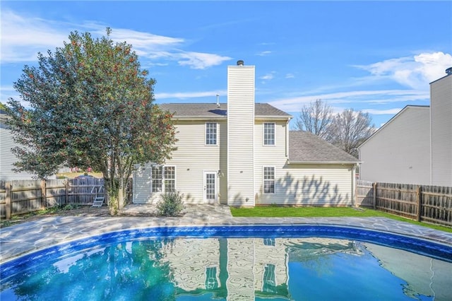 view of swimming pool with a patio area, a fenced in pool, and a fenced backyard