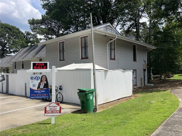 4312 Idlewood Ln, Tucker, GA 30084 - view of side of home featuring a chimney and a yard