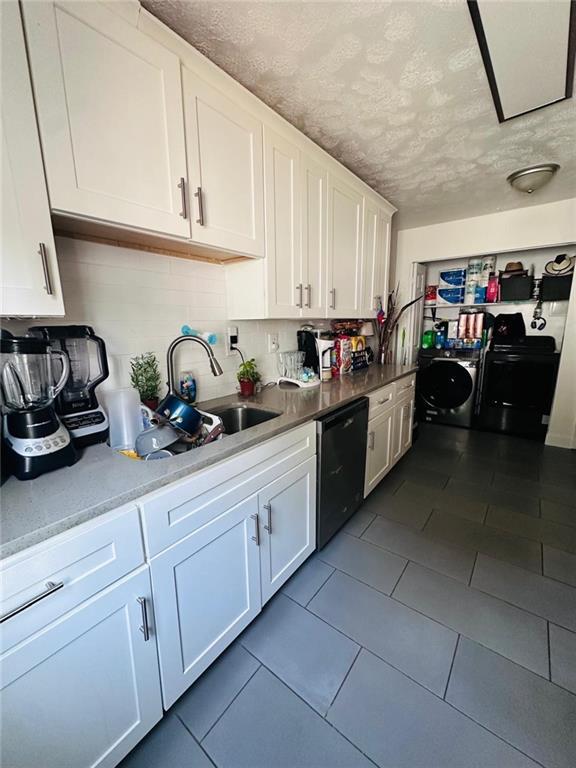 4312 Idlewood Ln, Tucker, GA 30084 - kitchen with dishwasher, white cabinets, a textured ceiling, a sink, and decorative backsplash
