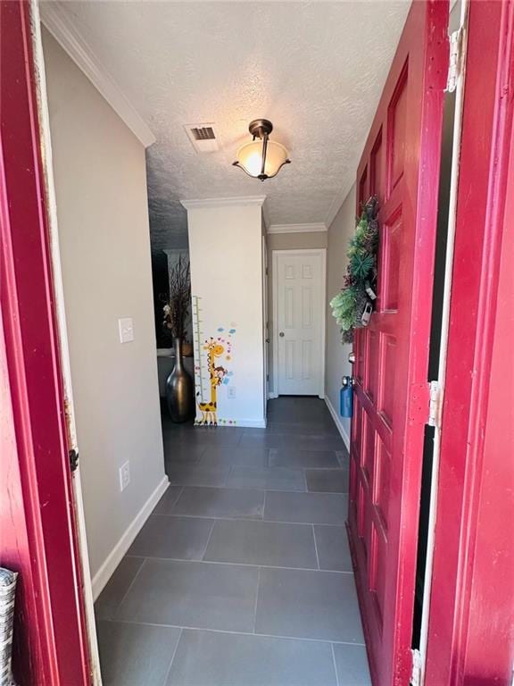 4312 Idlewood Ln, Tucker, GA 30084 - entrance foyer featuring dark tile patterned floors, baseboards, a textured ceiling, and ornamental molding