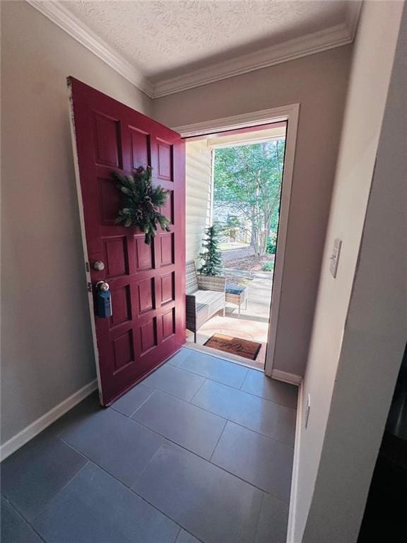 4312 Idlewood Ln, Tucker, GA 30084 - foyer entrance featuring baseboards, a textured ceiling, ornamental molding, and dark tile patterned floors