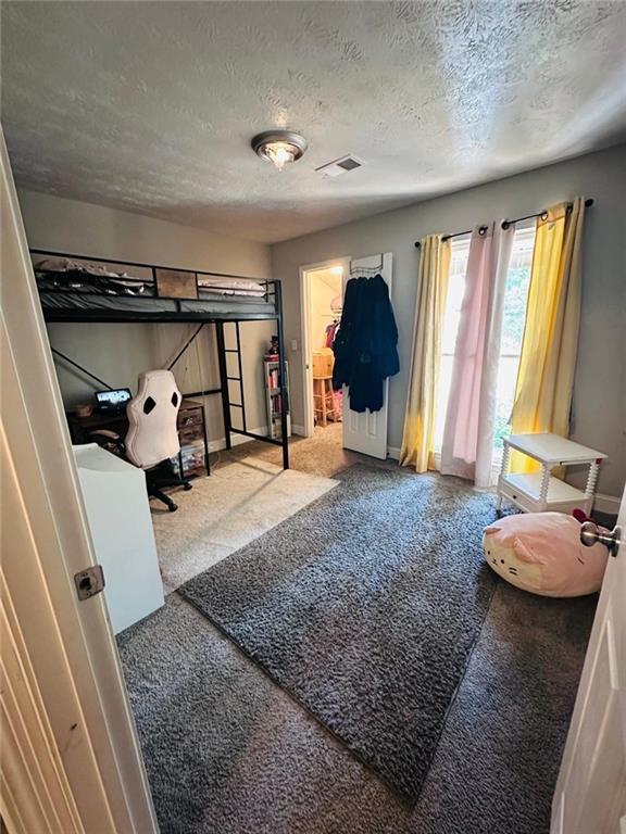 4312 Idlewood Ln, Tucker, GA 30084 - bedroom with carpet, baseboards, and a textured ceiling
