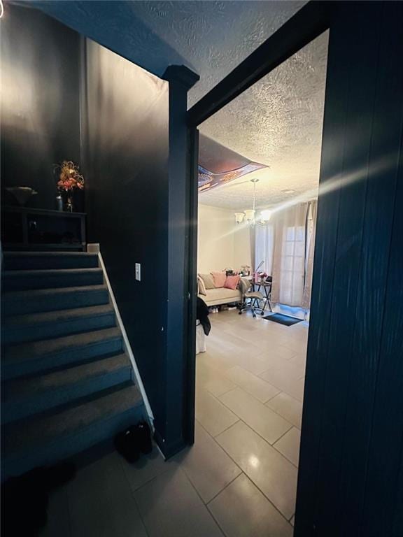 4312 Idlewood Ln, Tucker, GA 30084 - stairs with a textured ceiling, a chandelier, and tile patterned floors