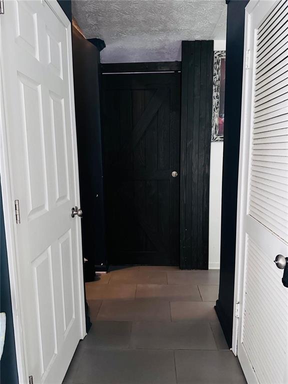 4312 Idlewood Ln, Tucker, GA 30084 - corridor featuring tile patterned floors and a textured ceiling