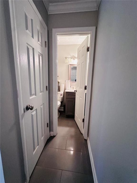 4312 Idlewood Ln, Tucker, GA 30084 - hallway featuring dark tile patterned flooring, baseboards, and crown molding