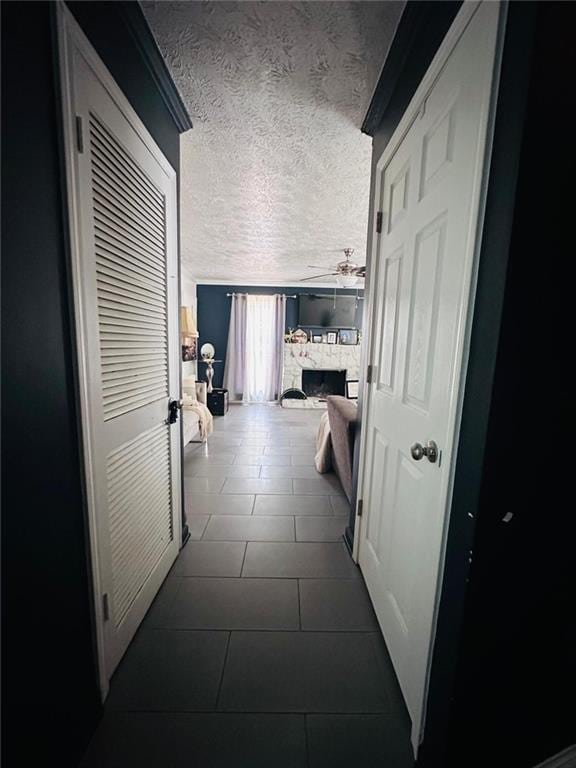 4312 Idlewood Ln, Tucker, GA 30084 - hallway with a textured ceiling and dark tile patterned flooring