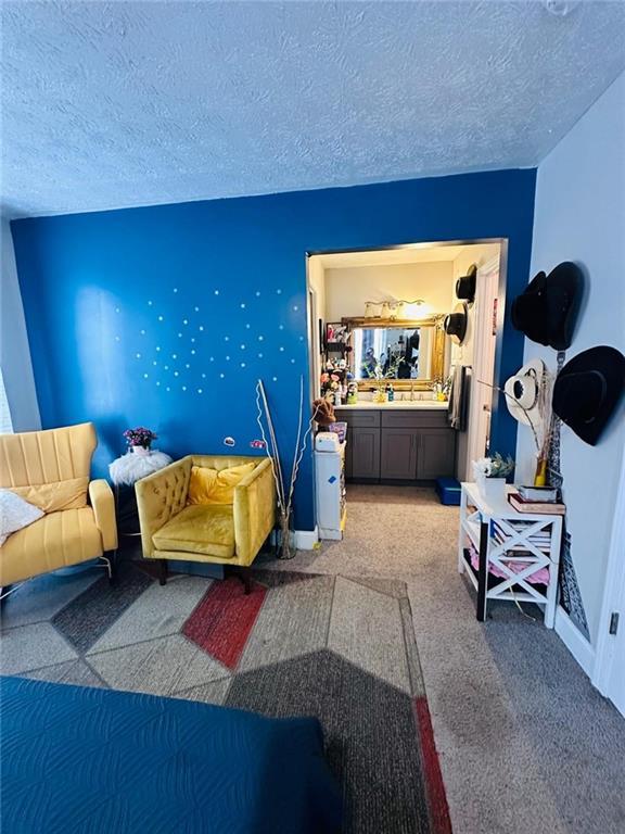 4312 Idlewood Ln, Tucker, GA 30084 - living area featuring light carpet, a textured ceiling, and baseboards